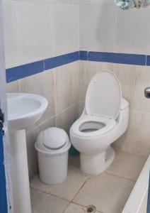 a bathroom with a toilet and a sink at CASA HOSPEDAJE LA FLORIDA in Cusco