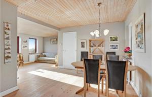 a dining room and living room with a table and chairs at Gorgeous Home In Bandholm With Kitchen in Bandholm