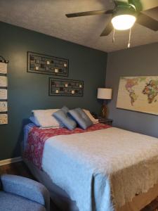 a bedroom with a bed and a ceiling fan at Indys Hidden Gem in Indianapolis