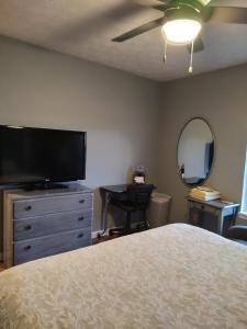 a bedroom with a bed and a flat screen tv at Indys Hidden Gem in Indianapolis
