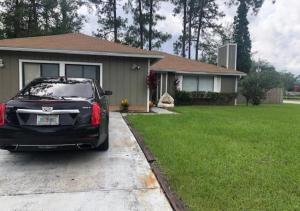 a black car parked in front of a house at Comfy Beautiful 3 bedroom Home in Jacksonville in Jacksonville