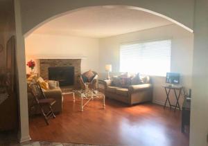 a living room with a couch and a fireplace at Comfy Beautiful 3 bedroom Home in Jacksonville in Jacksonville