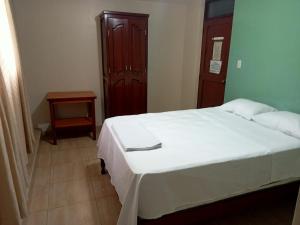 Postel nebo postele na pokoji v ubytování ROARI HOTEL