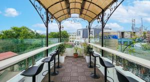 a balcony with chairs and plants on a roof at Affa Boutique Hotel in Hanoi