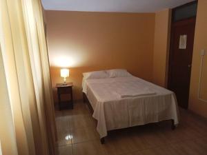 Postel nebo postele na pokoji v ubytování ROARI HOTEL