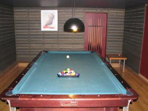 a pool table with a ball in a room at Sveciu Namai Giles in Alytus +1 photo