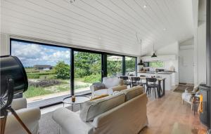 a living room with white furniture and a large window at 3 Bedroom Stunning Home In Knebel in Knebel