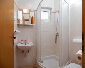 a bathroom with a shower and a toilet and a sink at House Marta in Baška Voda +46 photos