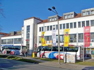 two buses parked in front of a building at Hotel Amadeus ROYAL Berlin in Berlin