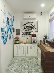 a kitchen with white cabinets and a tile floor at Phi Phi Indigo Hotel in Phi Phi Islands