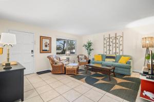 a living room with a couch and chairs at Waves 18 in St Pete Beach