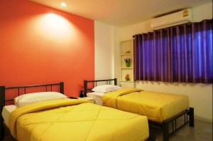 Postel nebo postele na pokoji v ubytování Noble House Chiangmai