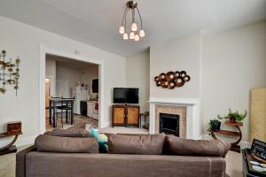 a living room with a couch and a fireplace at 9 Bedrooms, 3 Kitchens, 3 Baths, Sleep 20 Downtown in Indianapolis
