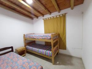 a bedroom with two bunk beds in a room at Cabañas Florida Del Sur in San Rafael +22 photos