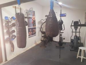 a gym with two punching bags hanging on the wall at Villa casamarbella in Karangasem
