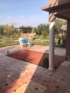 eine Terrasse mit einem Tisch und Stühlen darauf in der Unterkunft Walid in Marrakesch