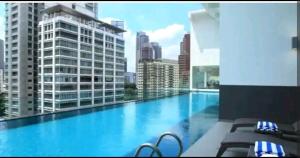 a large swimming pool with a view of a city at Roomy Suites @One Bukit Ceylon in Kuala Lumpur