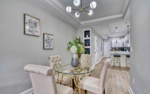 a dining room with a glass table and chairs at On Ensor in Baltimore