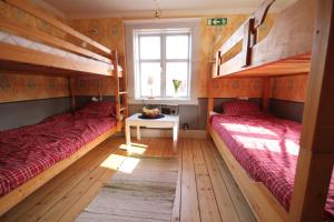 1 dormitorio con 2 literas y ventana en Mallboden Café & Vandrarhem, en Motala