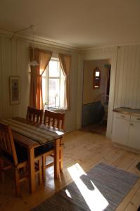 a dining room with a table and chairs and a window at Mallboden Café & Vandrarhem in Motala