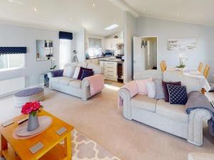 a living room with two couches and a table at Ocean Retreat Lodge in Corton