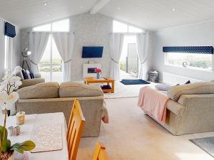 a living room with a couch and a table at Ocean Retreat Lodge in Corton