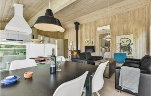 a dining room and living room with a table and chairs at Nice Home In Humble With Sauna in Humble