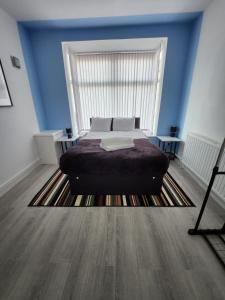 a bedroom with a bed and a large window at Bamville Shared House in Birmingham