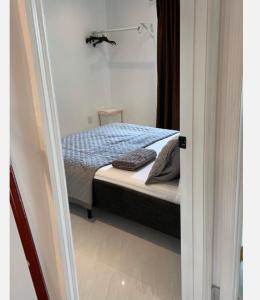 a bedroom with a bed in a white room at Bedroom and Bathroom 4 in Boca Raton