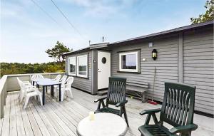 una terrazza con sedie e tavoli e una casetta di Cozy Home In Stathelle With Kitchen a Stathelle