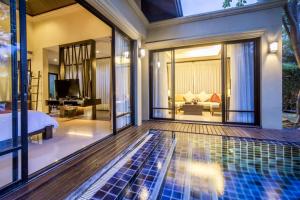 a villa with a swimming pool and a bedroom at TUI BLUE The Passage Samui Pool Villas with Private Beach Resort in Ban Bang Po