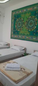 a group of beds with towels on top of them at KAMIR Guest House in Bukhara
