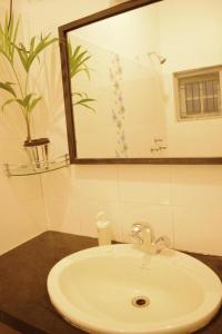 a bathroom with a white sink and a mirror at BE ANIMAL Hostel in Bangalore