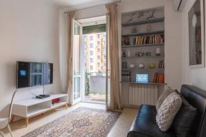 a living room with a couch and a television at Vatican Corner Family Apartment in Rome