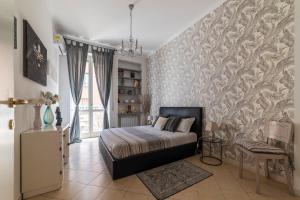 a bedroom with a bed and a wall at Vatican Corner Family Apartment in Rome