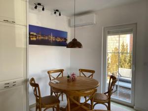 a dining room with a table and chairs and a window at ViLLA in Peje