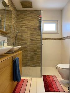 a bathroom with a shower and a sink and a toilet at ViLLA in Peje