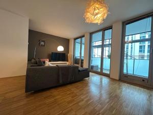 a large living room with a couch and a chandelier at Liboria I Olympiapark München in Munich