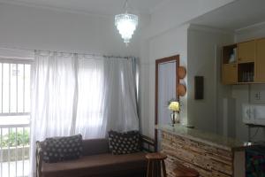 a living room with a couch in front of a window at Apartamento Casa da Praia in Cabo Frio +23 photos