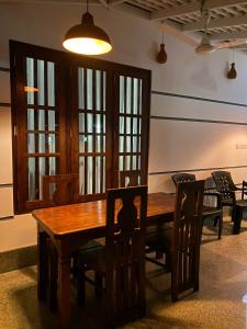烏納瓦圖納的住宿－Oshi villa，一间带木桌和椅子的用餐室