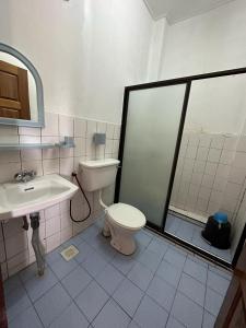 a bathroom with a toilet and a sink at Fairy Garden Resort Kundasang in Kundasang