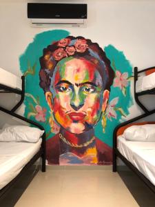 a mural of a woman with roses on her head at Villa Leo in Cancún