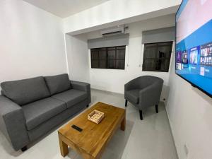 a living room with a couch and a table and a tv at NUEVO y moderno en Alta Córdoba in Córdoba