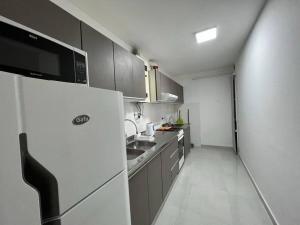 a small kitchen with a refrigerator and a sink at NUEVO y moderno en Alta Córdoba in Córdoba