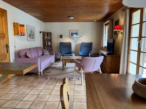 a living room with a couch and chairs and a table at Wasserhügeli in Fiesch