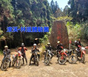 a group of people on motorcycles on a dirt road at MILU Backpacker Hostel in Puli