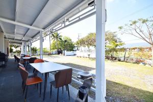 a patio with tables and chairs and a view of a park at 文旅行民宿-莊園館-寵物友善 in Taitung City