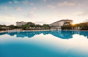 a large swimming pool with buildings in the background at Ela Excellence Resort Belek in Belek