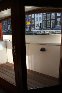 
a kitchen with a door open and a window at Prinsenboot in Amsterdam
