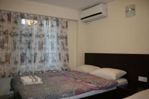 a small bedroom with a bed and a window at Marmara Apartments in Istanbul